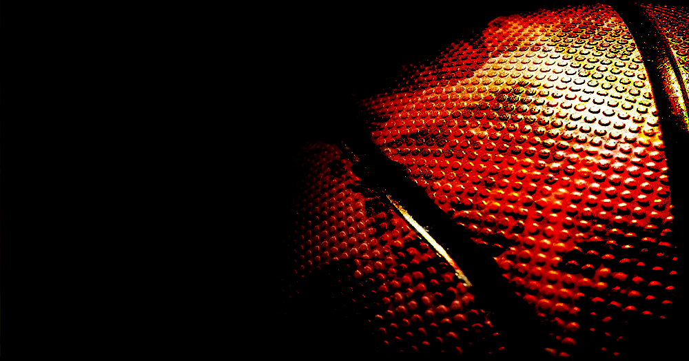 Close-up of an orange basketball against a dark background